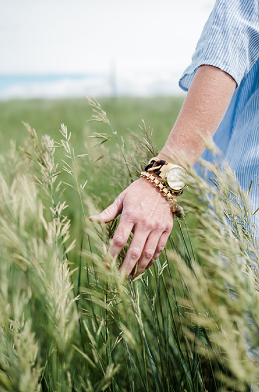hand through grass